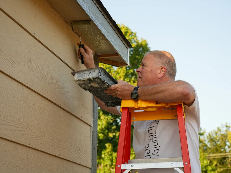 Rocky of Bank of America paints a home.