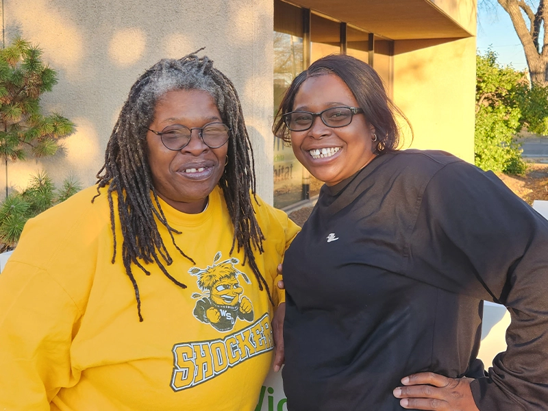Family partners Chalisa and Angela smiling together.