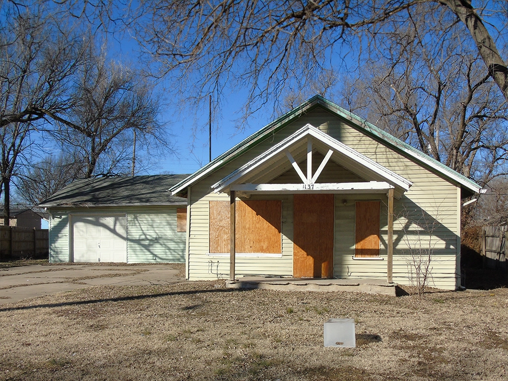 A front view of a home in the Rock the Block neighborhood before it was renovated.