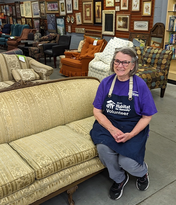 Core volunteer Connie sitting on a couch.